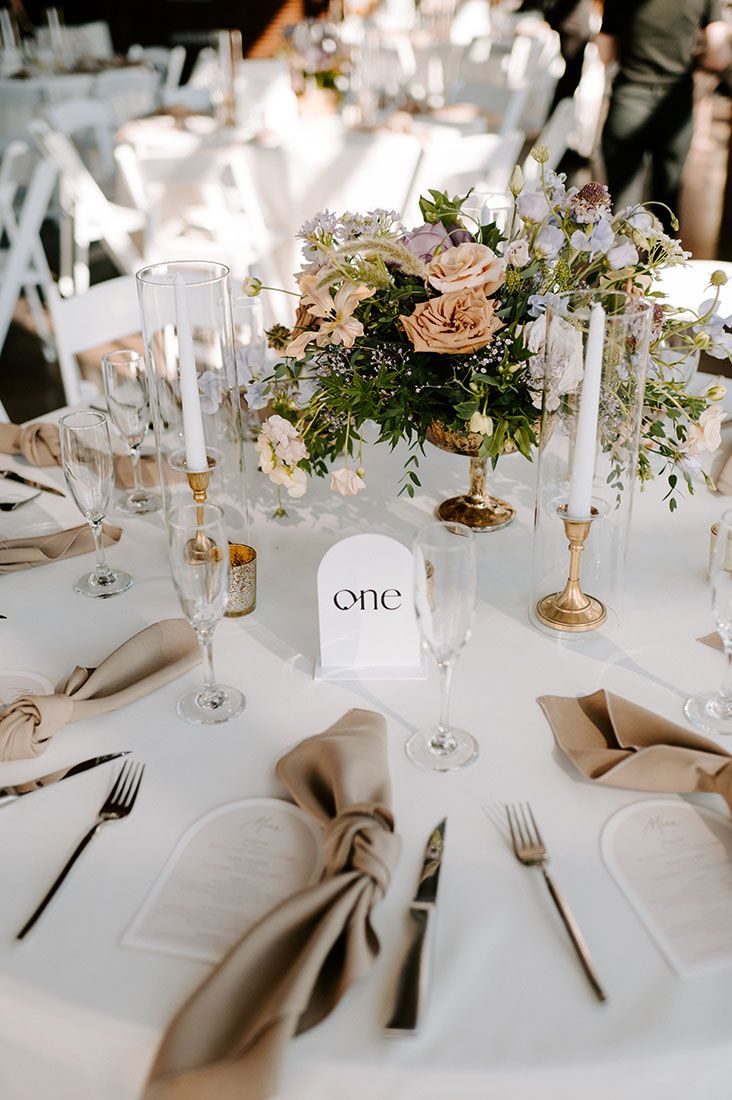 the table is set with white linens and silverware