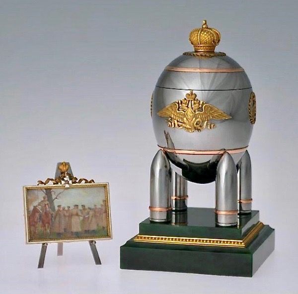 a silver and gold object sitting on top of a wooden stand next to a painting