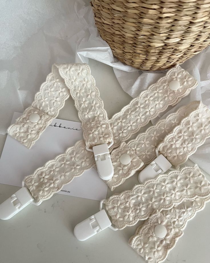 three pieces of white garter sitting on top of a table next to a basket