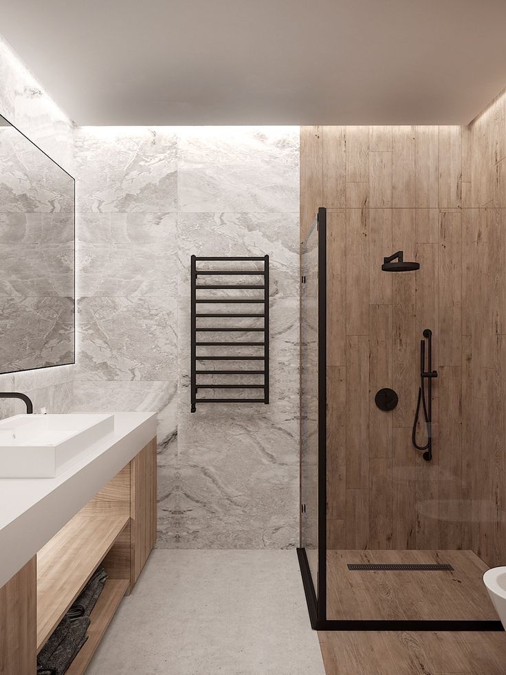 a modern bathroom with marble walls and flooring, along with a walk in shower