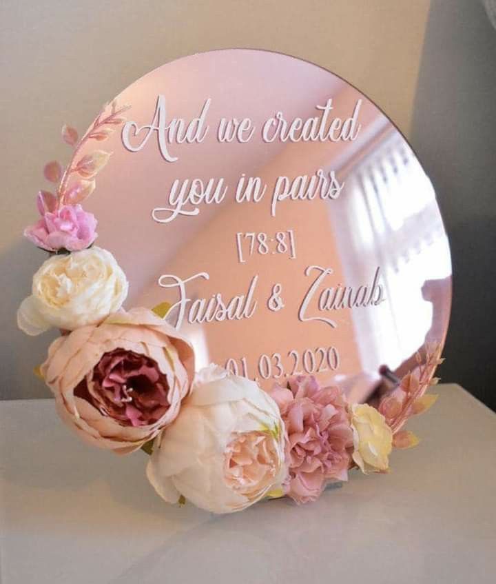 a mirror that has some flowers on it with the words and we created you in paris