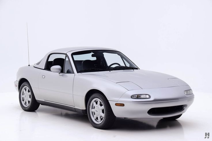 a white sports car is parked on the floor in front of a white background and there are no people around it