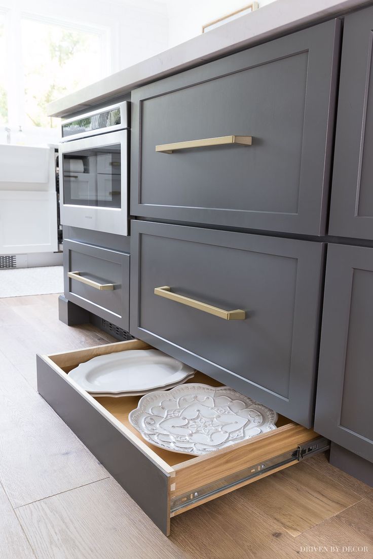 an open drawer in the middle of a kitchen