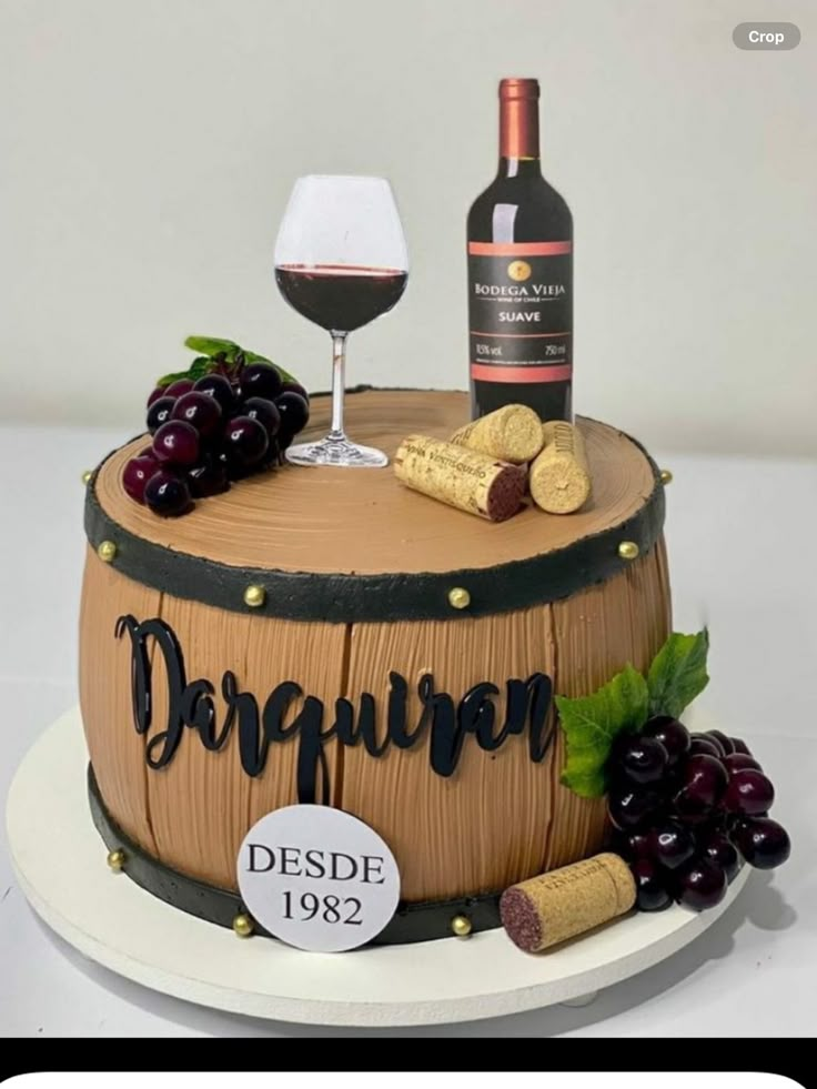 a cake with wine and grapes on it