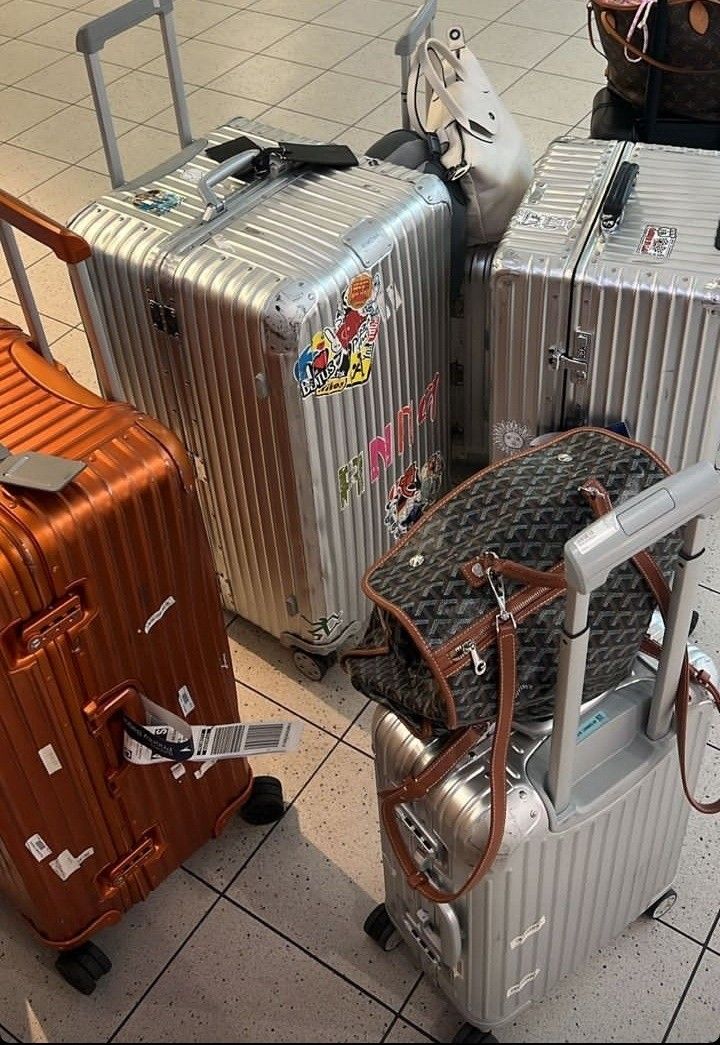 three suitcases are lined up on the floor