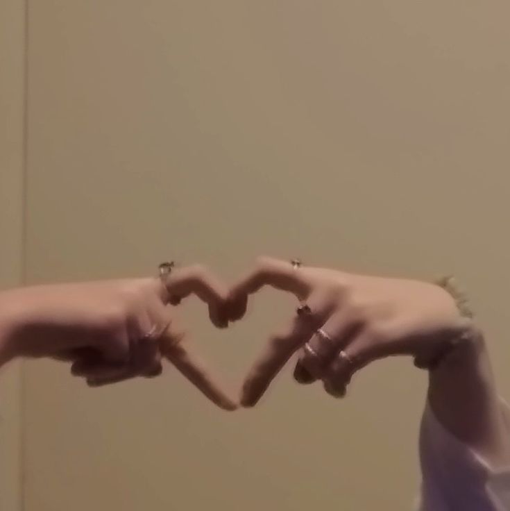 two hands making a heart shape with their fingers