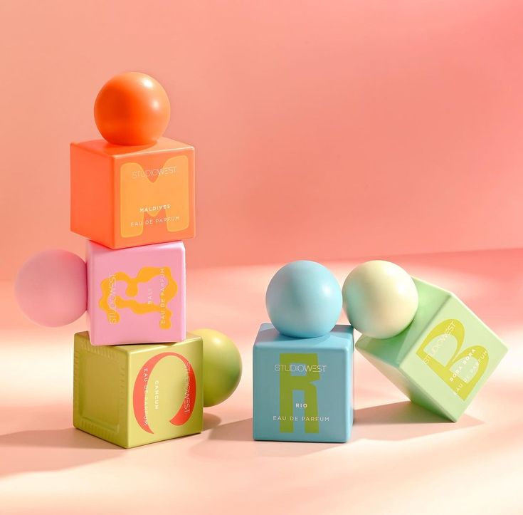 an assortment of colorful blocks and balls in front of a pink background with the letter d on top