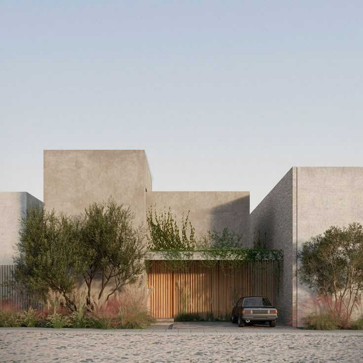 a car parked in front of a concrete building with trees and bushes on the side