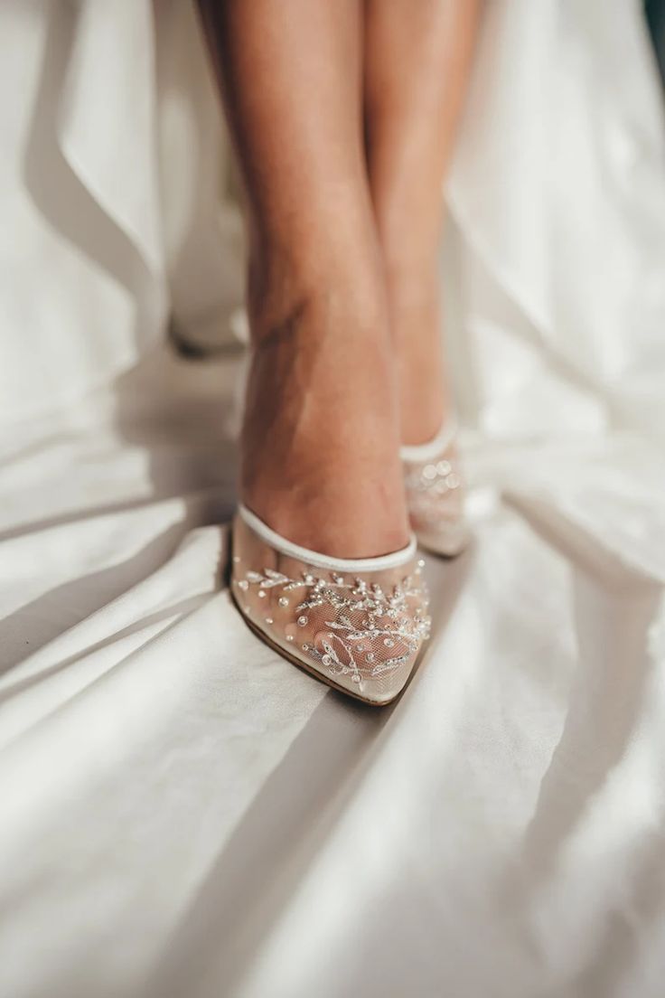 the bride's shoes are adorned with sequins