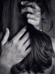 a man with long hair is combing another mans hair in black and white photo