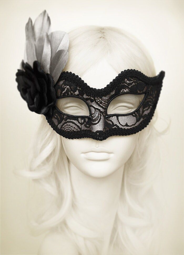 Venetian style masquerade mask covered black lace on metallic silver surface. Framed with black braided trim, small black rhinestones on the corners of the eyes. Decorated with black satin rose and silver feathers. Your order will be delivered with online tracking by UPS or TNT. Back surface is also covered with fabric for comfortable use. Ribbons are added both sides to tie. Base mask is made of paper mache. Standard size fits most (for women). This classical Venetian mask is perfect for any co Luxury Black Elegant Masks, Black Masquerade Mask For Halloween Wedding, Fitted Black Masquerade Mask For Mardi Gras, Fitted Black Masquerade Mask For Costume, Elegant Black Formal Mask, Black Masquerade Mask For Wedding Carnival, Elegant Black Masquerade Mask For Halloween, Elegant Black Mask For Costume Party, Black Formal Eye Mask