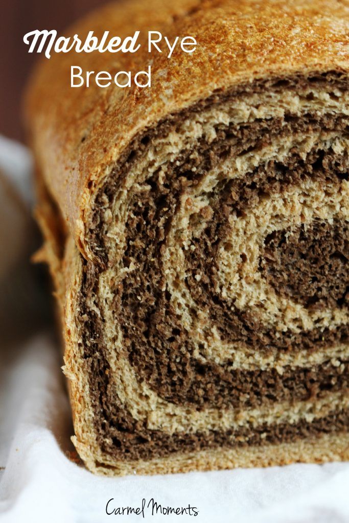 a close up of a sliced loaf of bread on a white napkin with the words marbled rye bread