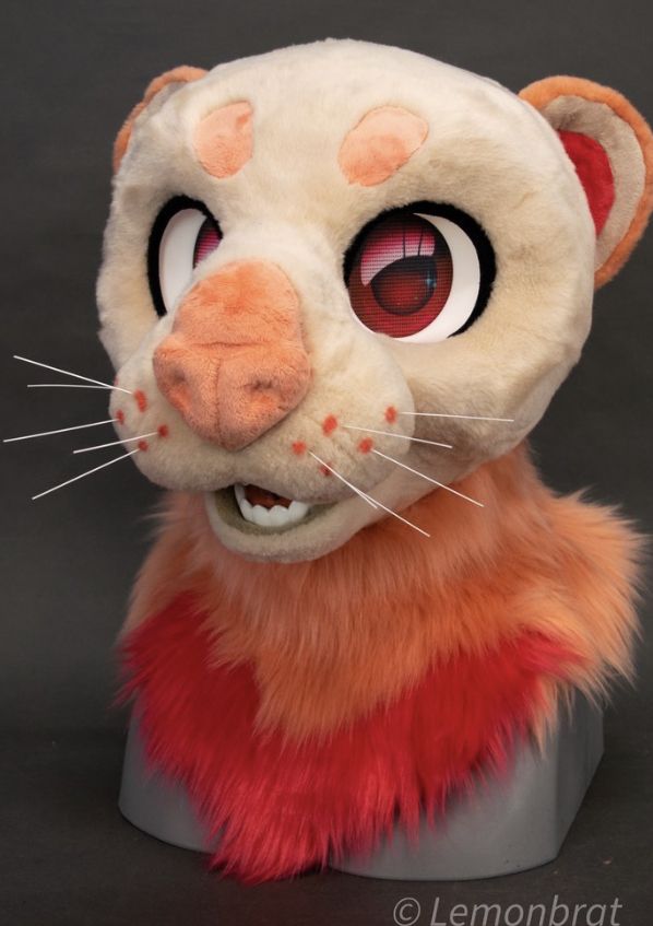 a stuffed animal with big eyes sitting on top of a table