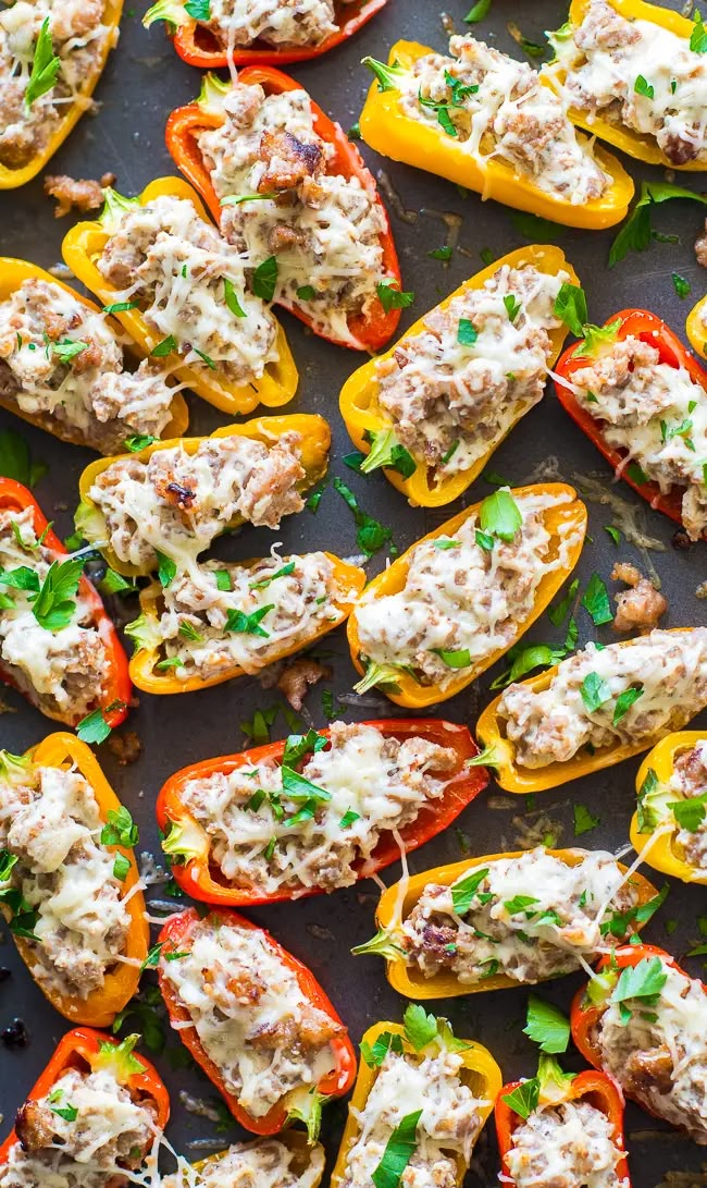 stuffed bell peppers with meat and cheese on a baking sheet, ready to be eaten