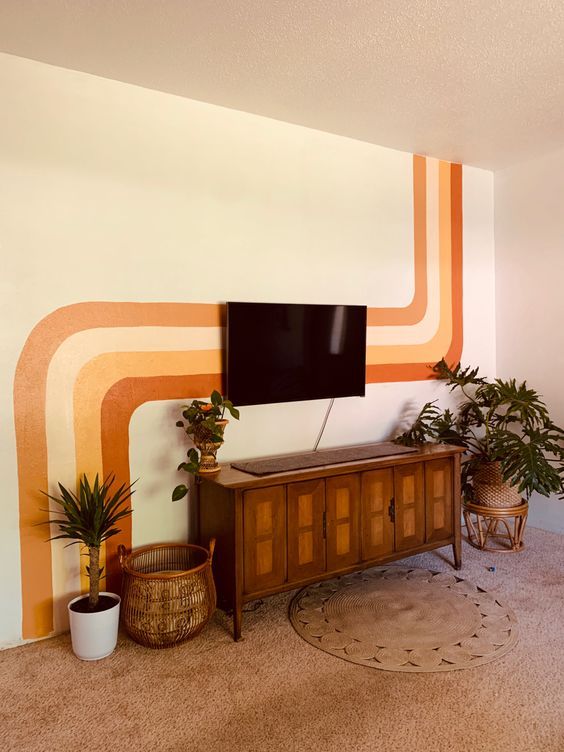 a living room with a large flat screen tv on top of a wooden entertainment center