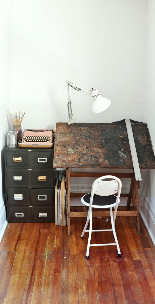 a chair and desk in a room with hard wood flooring on the wooden floors