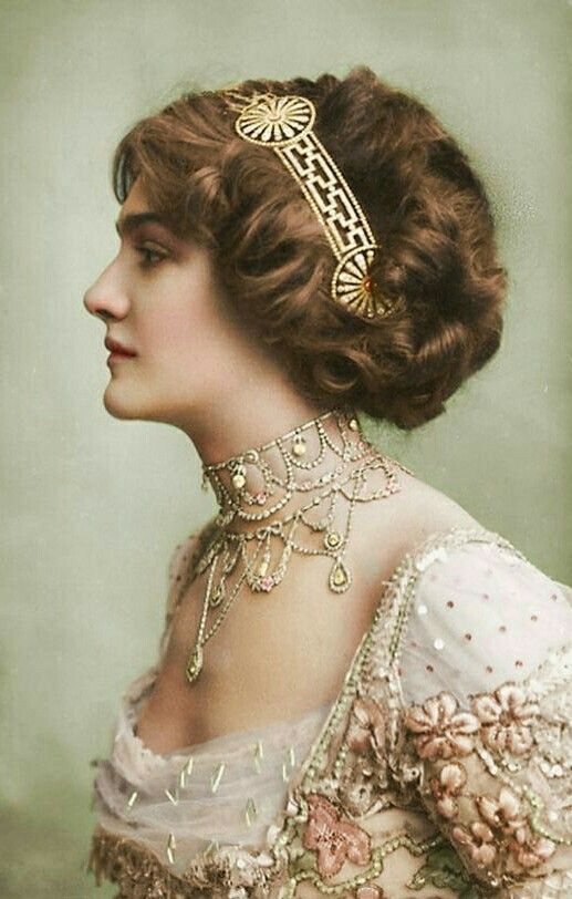 an old fashion photo of a woman wearing a tiara