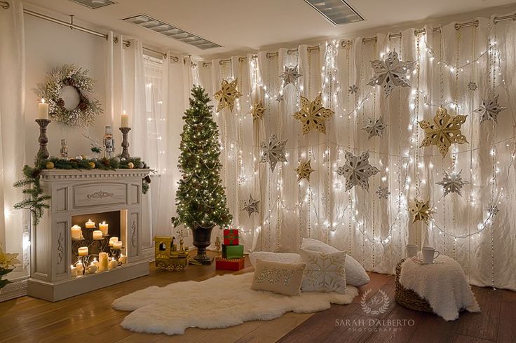 a living room decorated for christmas with lights on the wall and decorations around the fireplace