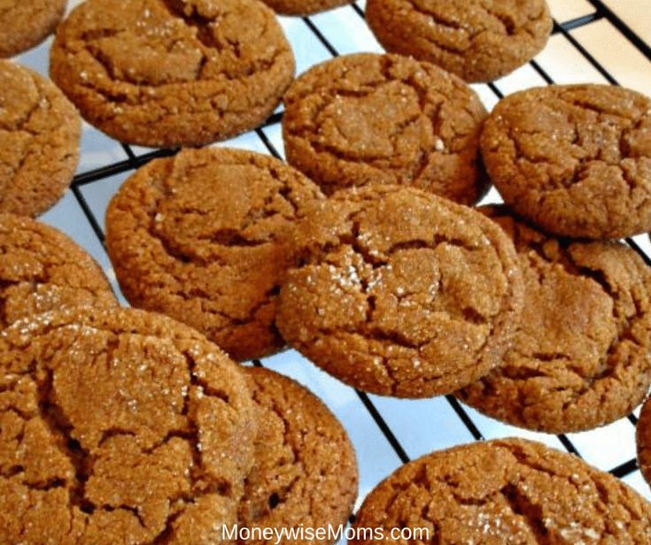 some cookies are cooling on a rack and ready to be baked in the oven for consumption