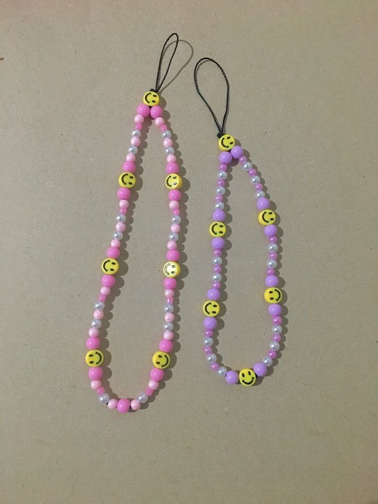 two necklaces with smiley faces on them