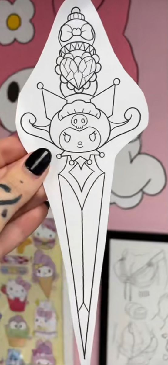 a person holding up a paper cut out of an ice cream cone with cartoon characters on it