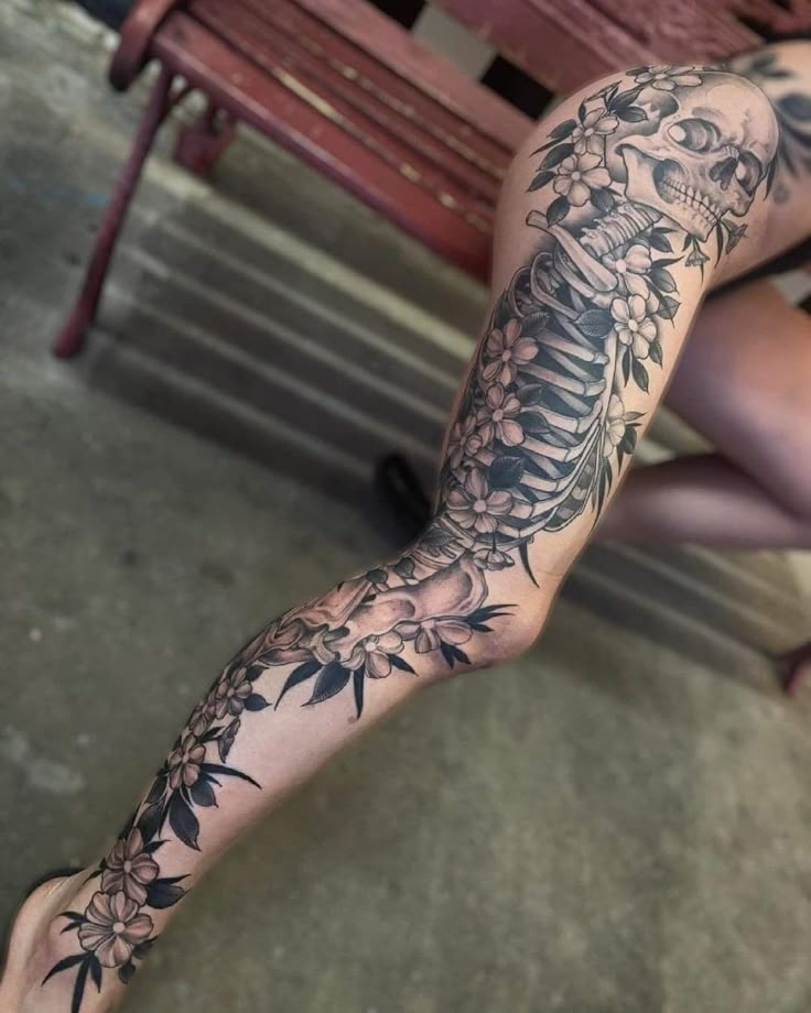 a woman sitting on top of a wooden bench next to a table covered in tattoos