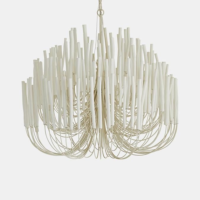 a chandelier made out of white sticks on a white background with one light hanging from the ceiling