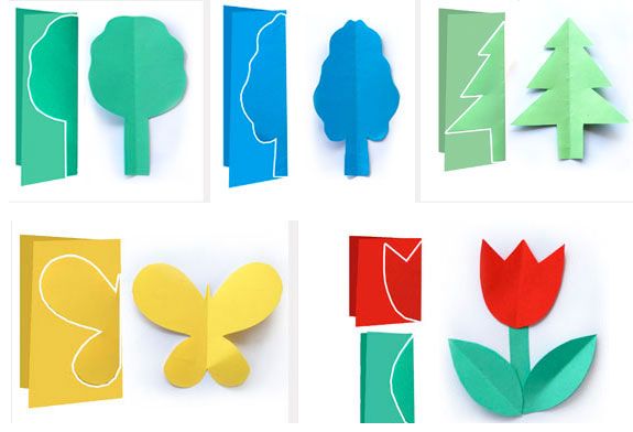 paper cut flowers and trees are arranged in different shapes, sizes, and colors on a white background