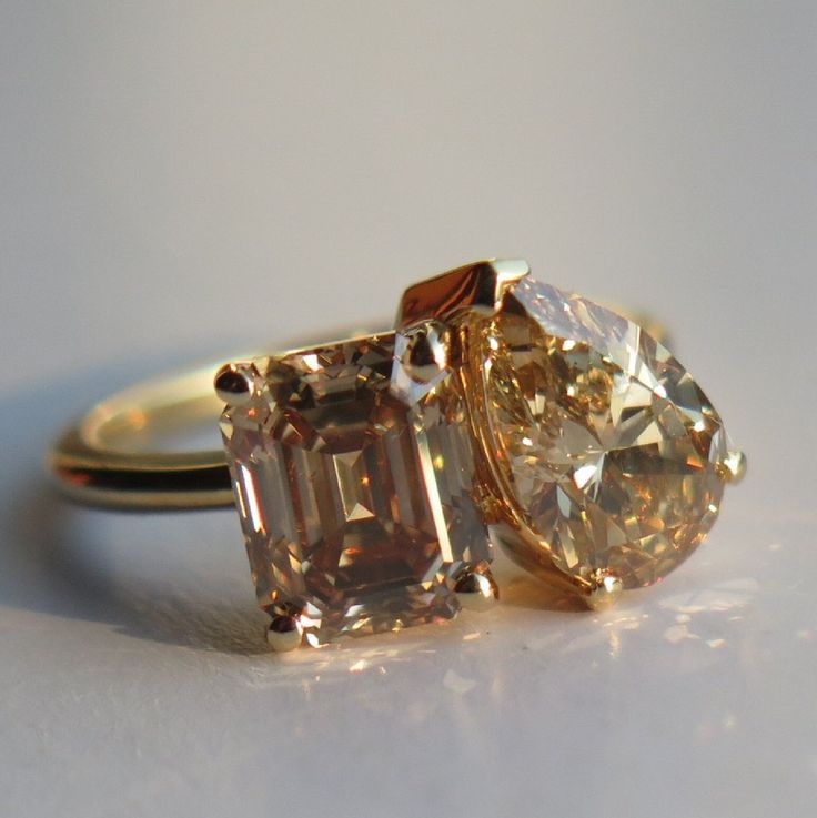 two yellow and white diamond rings sitting on top of each other