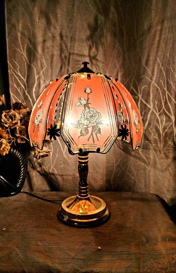 an orange lamp sitting on top of a wooden table