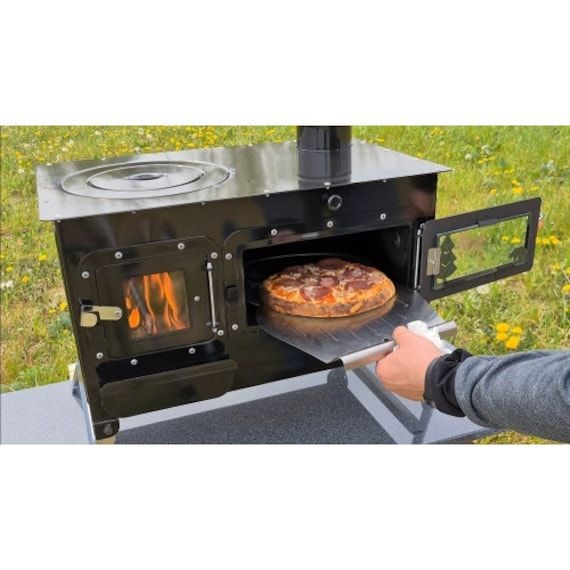 a man is pulling a pizza out of an outdoor wood burning oven with the door open