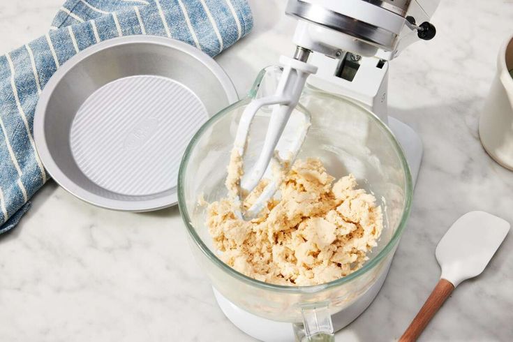 a blender filled with food on top of a counter next to other kitchen items