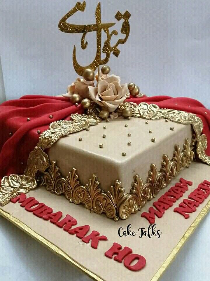 the cake is decorated with gold and red decorations