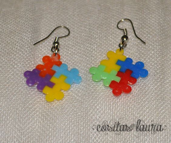 the earrings are made out of plastic puzzle pieces