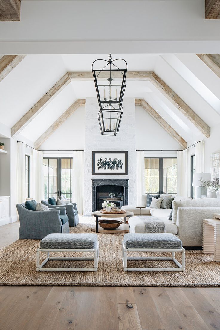 a living room filled with furniture and a fire place in the middle of an open floor plan