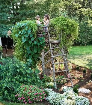 two children are climbing on a ladder in the garden