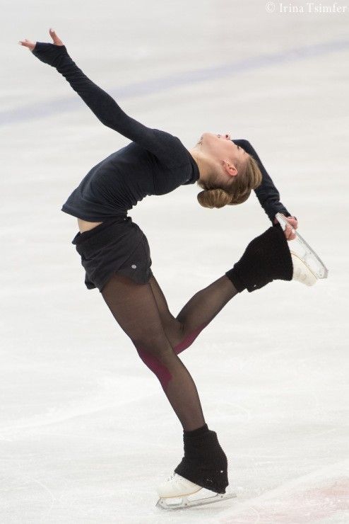 a female figure skating on an ice rink