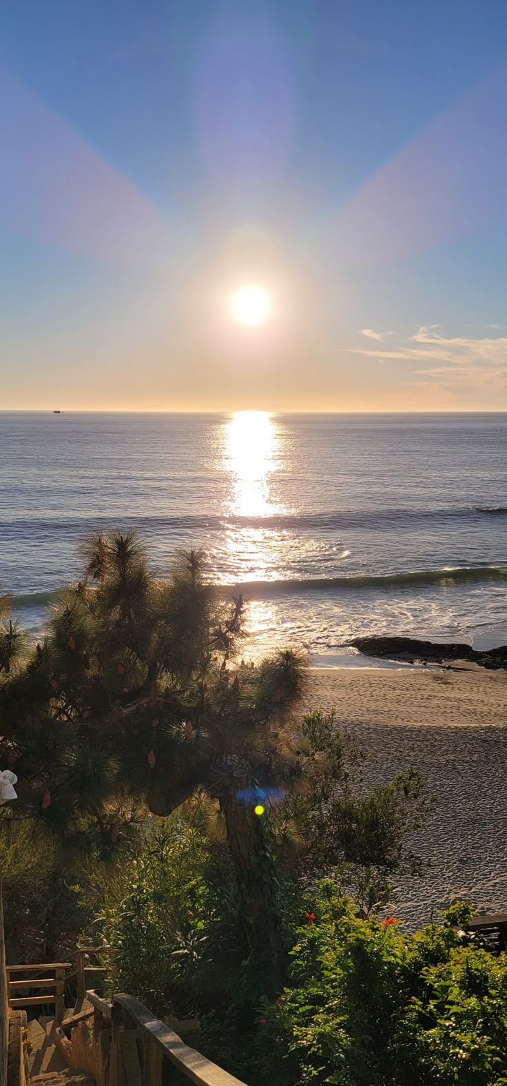 the sun is setting over the ocean and beach