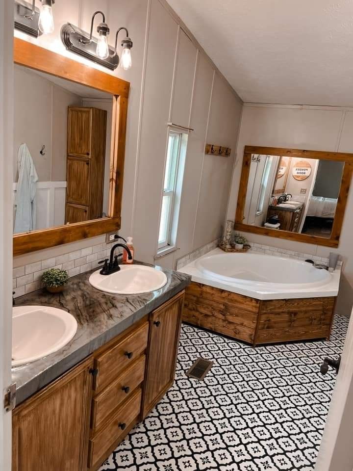 a bathroom with two sinks and a bathtub