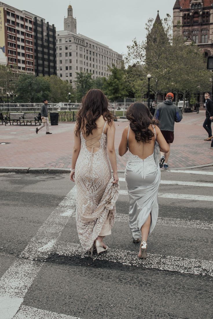 two women walking down the street in dresses