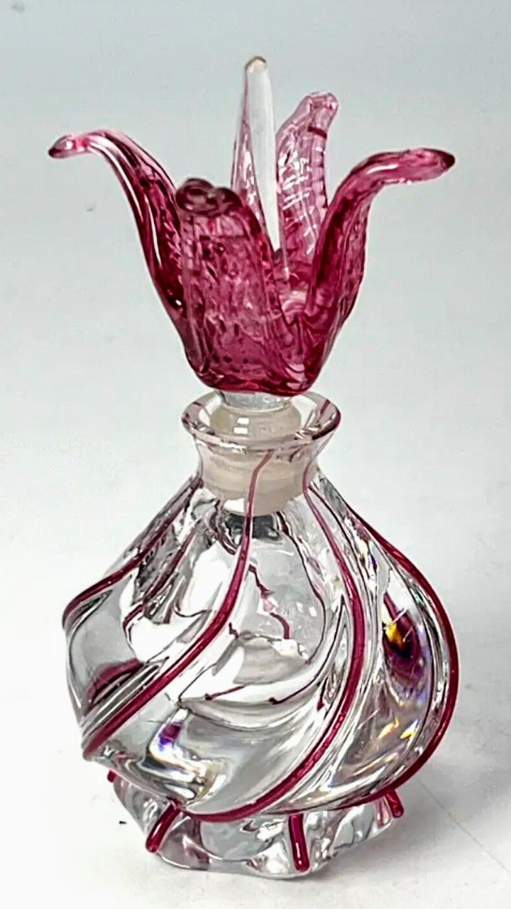 a clear glass vase sitting on top of a white table