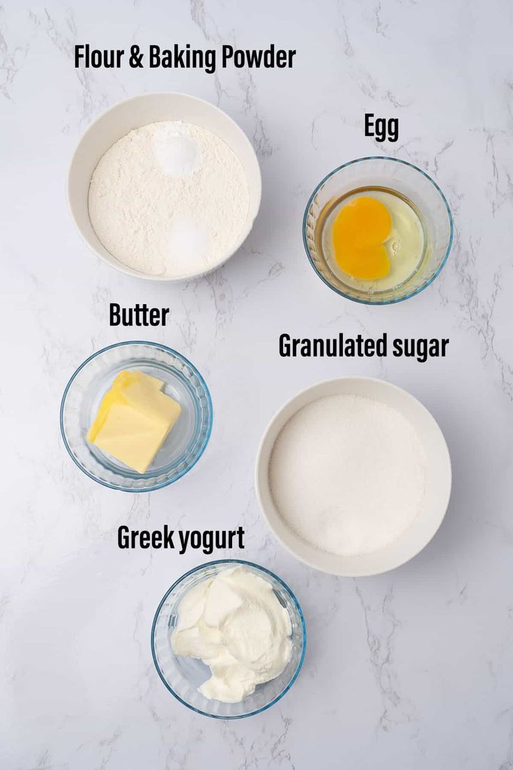 ingredients to make an egg muffin recipe on a white marble countertop with text overlay