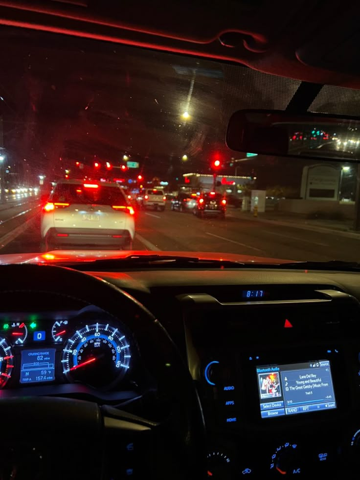 the dashboard of a car on a busy highway at night