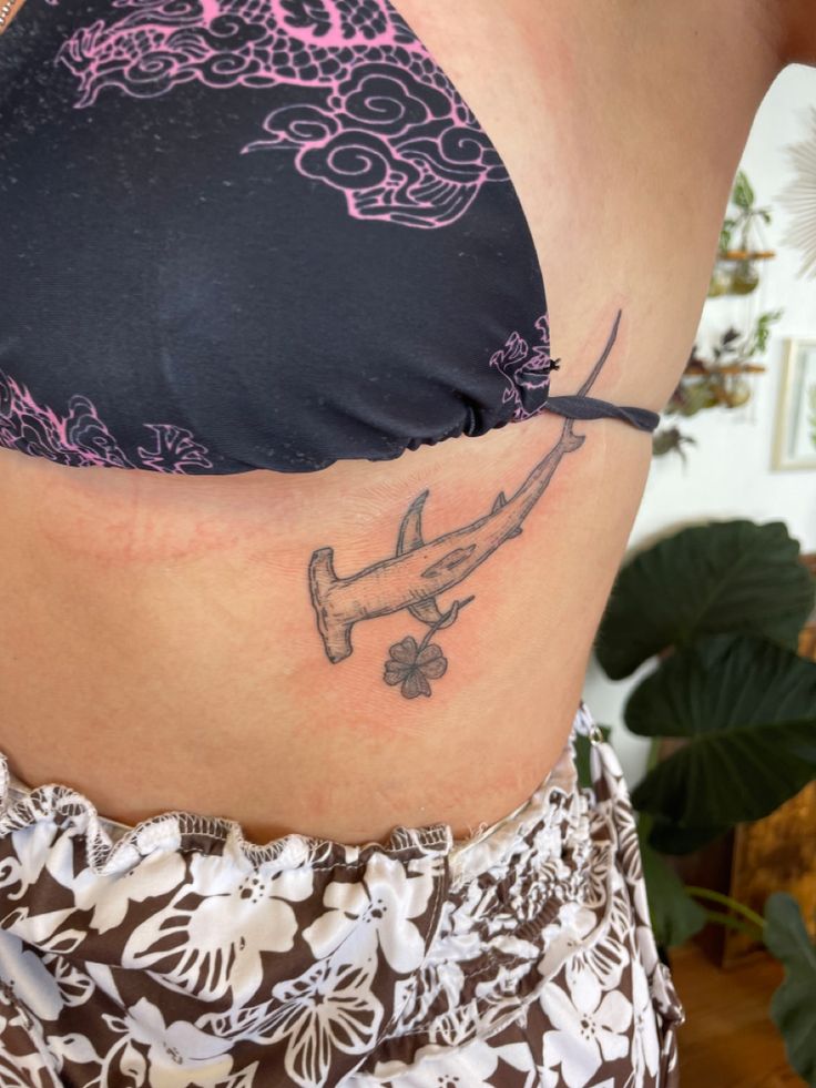 a woman with a tattoo on her stomach