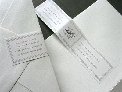 some white envelopes are laying next to each other on a table with two cards