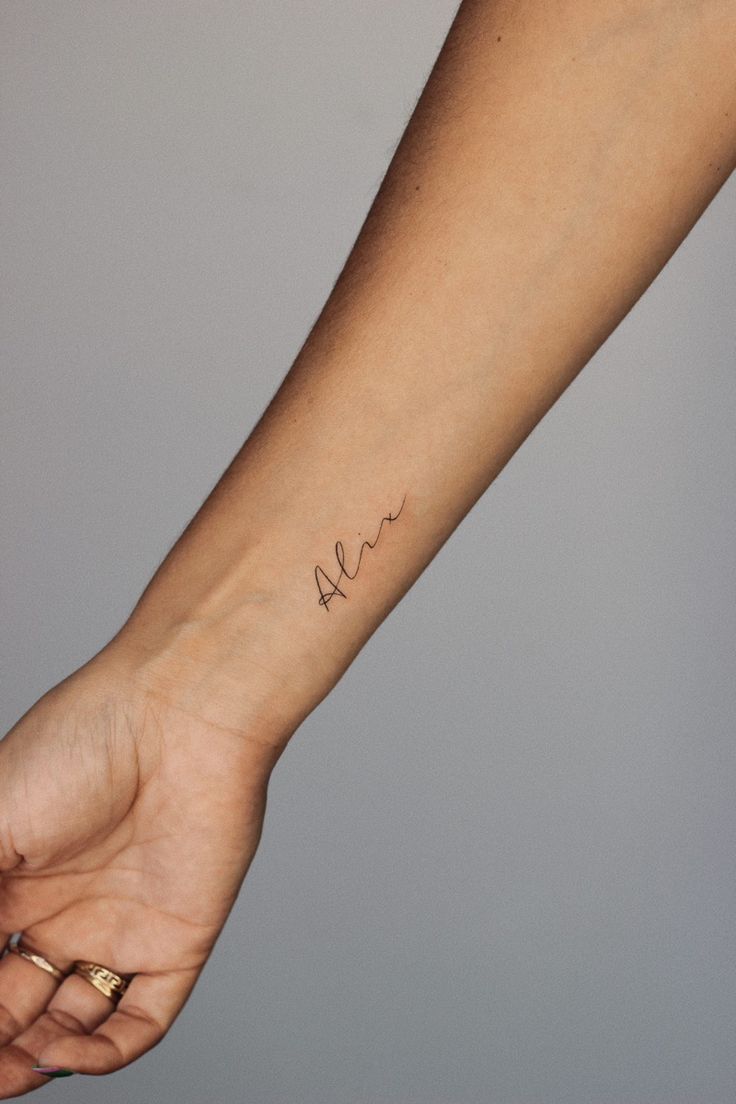 Wrist tattoo small fineline name alix Dainty Last Name Tattoo, Meet Name Tattoo, Dainty Tattoo For Son, Mini Name Tattoo, Tattoo For Daughter Name, Dainty Tattoo For Kids, Script Name Tattoo Forearm, Names On Wrist Tattoos, Child’s Name Tattoo Dainty