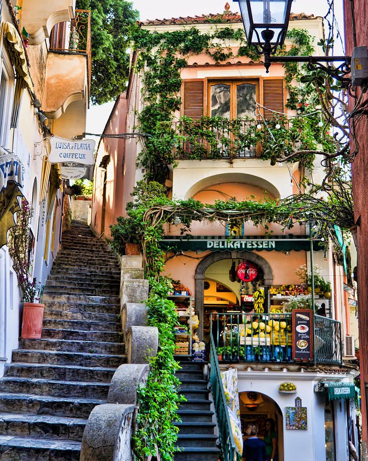 an image of stairs leading up to a building with plants growing on the walls and windows