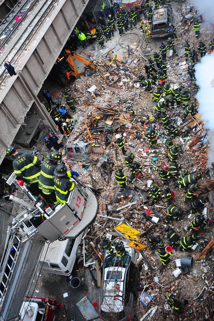 the firemen are working on the destroyed building