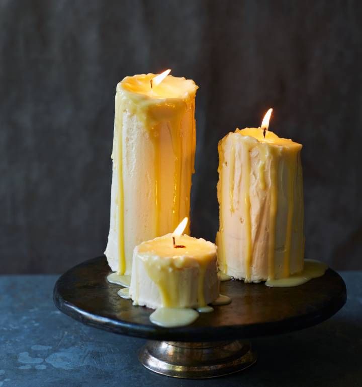 three candles sitting on top of a black plate