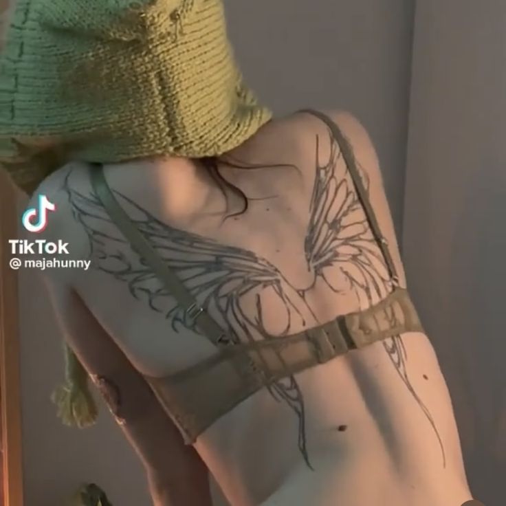 the back of a woman with tattoos on her body